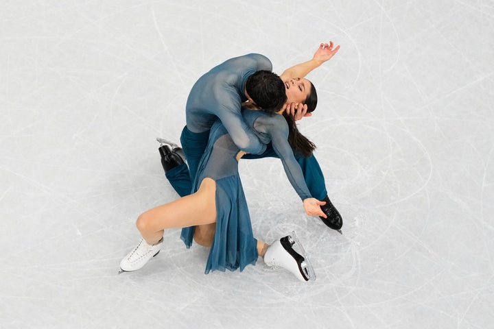 France's Guillaume Cizeron holds onto Laurence Fournier Beaudry as the ice dance duo competes in the free skate on Wednesday. (AP Photo/Bernat Armangue)